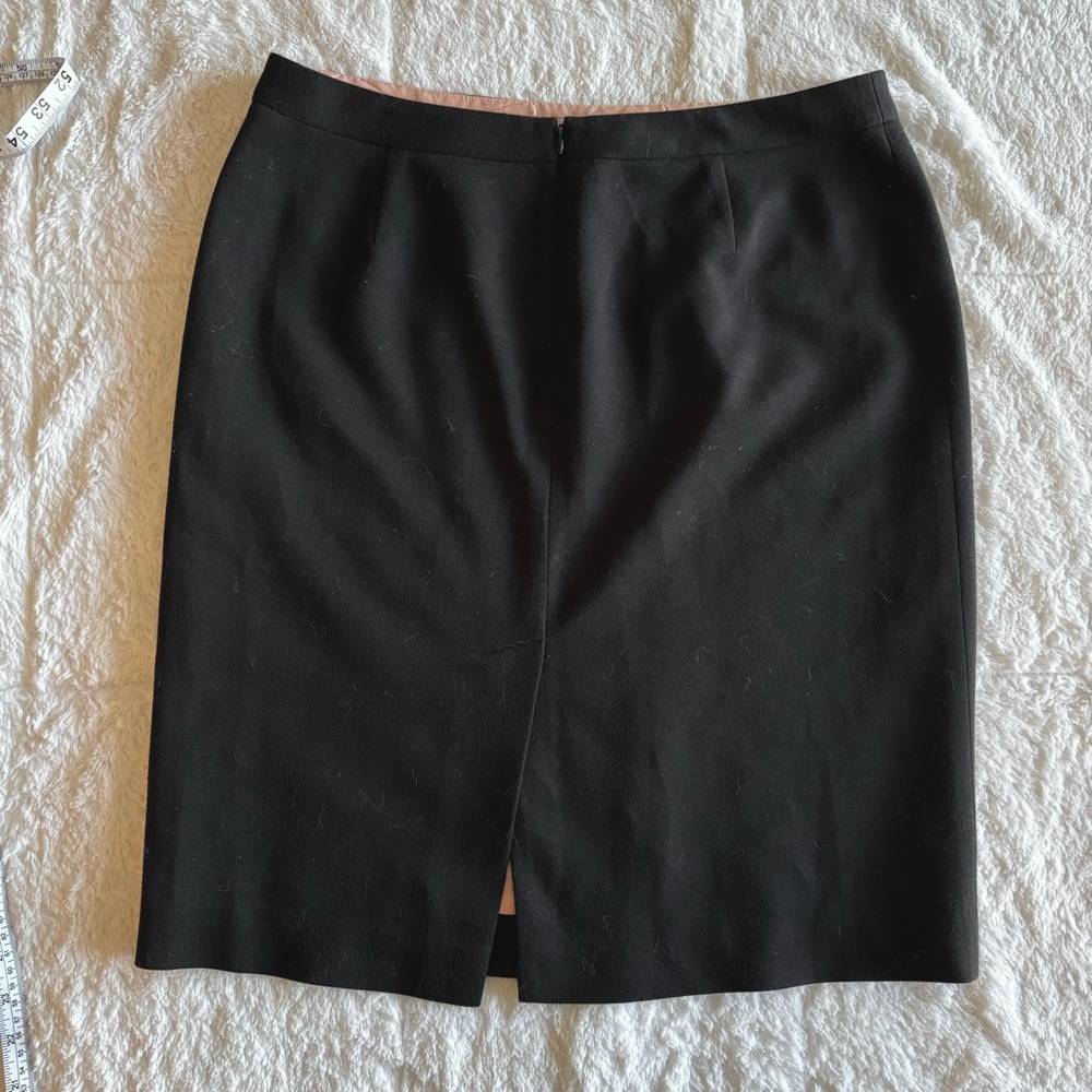 Black mini pencil skirt with satin-like pink slip underneath